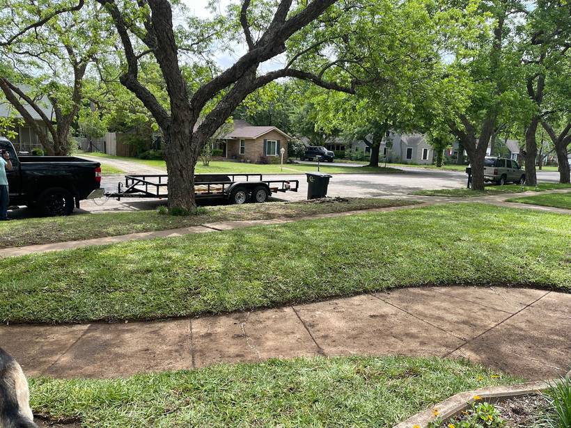 Fresh sod laid along a Fort Worth front yard next to the Yard Man trailer